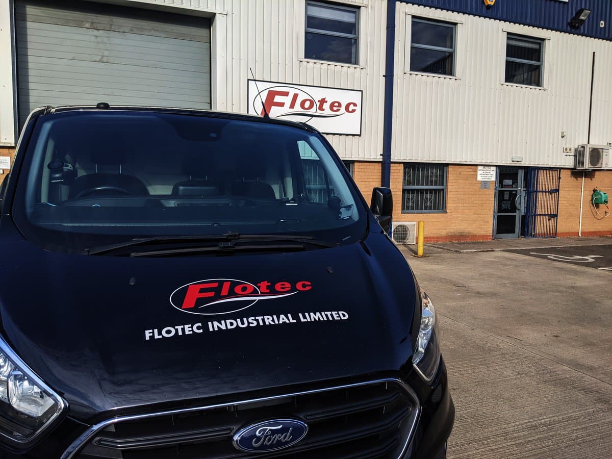 A branded Flotec van, outside the Head Office building.